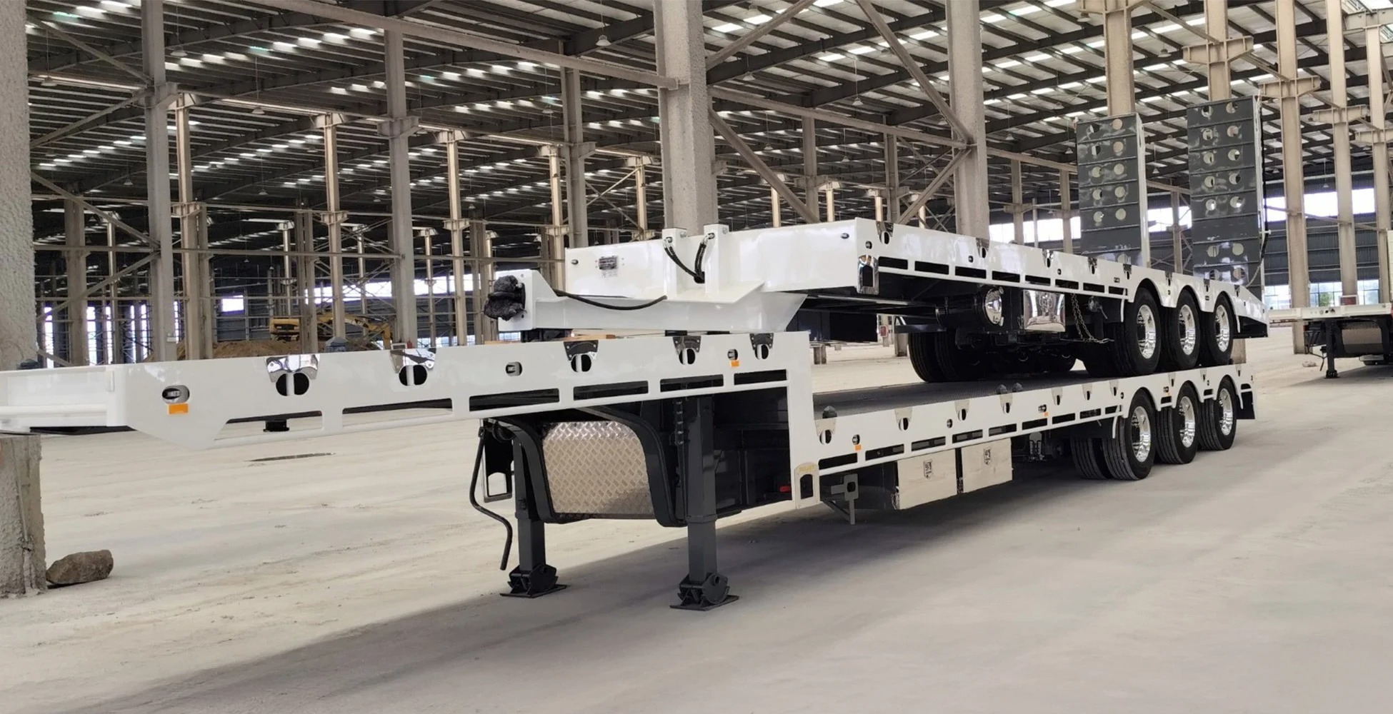 two white drop deck trailers