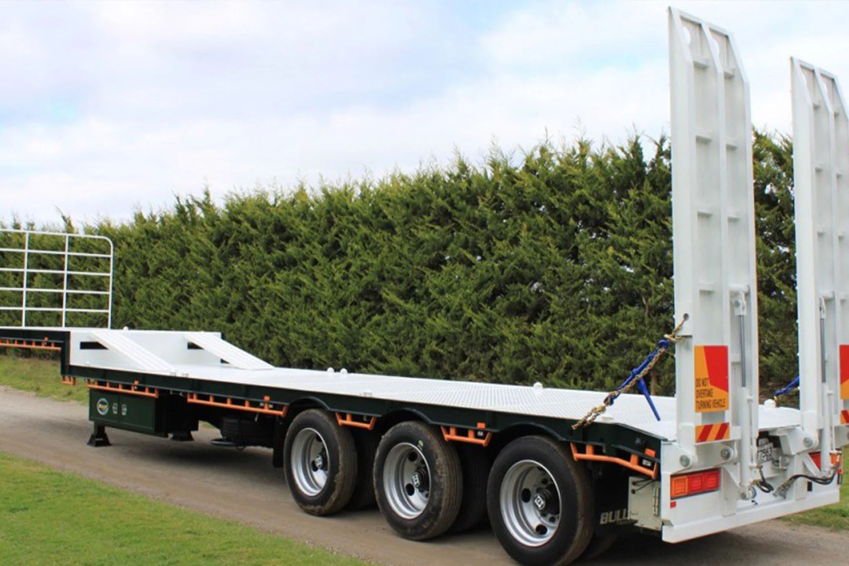 a white and black drop deck trailer
